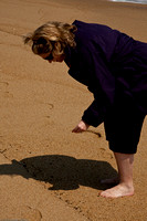 Kathy checks out sea shells by the sea shore