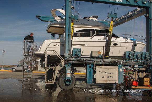 Ivan climbs to his boat to finish securing it for winter storage
